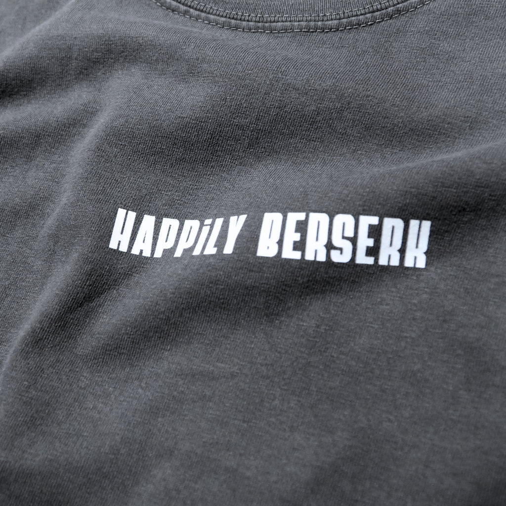 Close-up of a vintage black long-sleeved  t-shirt featuring the phrase 'HAPPILY BERSERK' printed across the chest in vintage white varsity-style lettering.