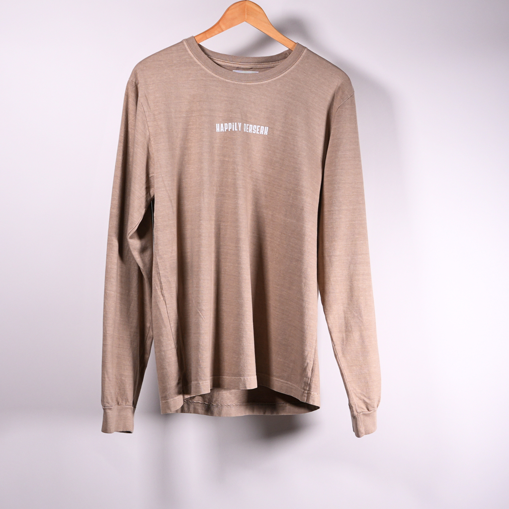 A vintage tan crewneck shirt hanging on a wooden hanger against a light  background, featuring the text 'HAPPILY BERSERK' printed in VINTAGE white on the chest.