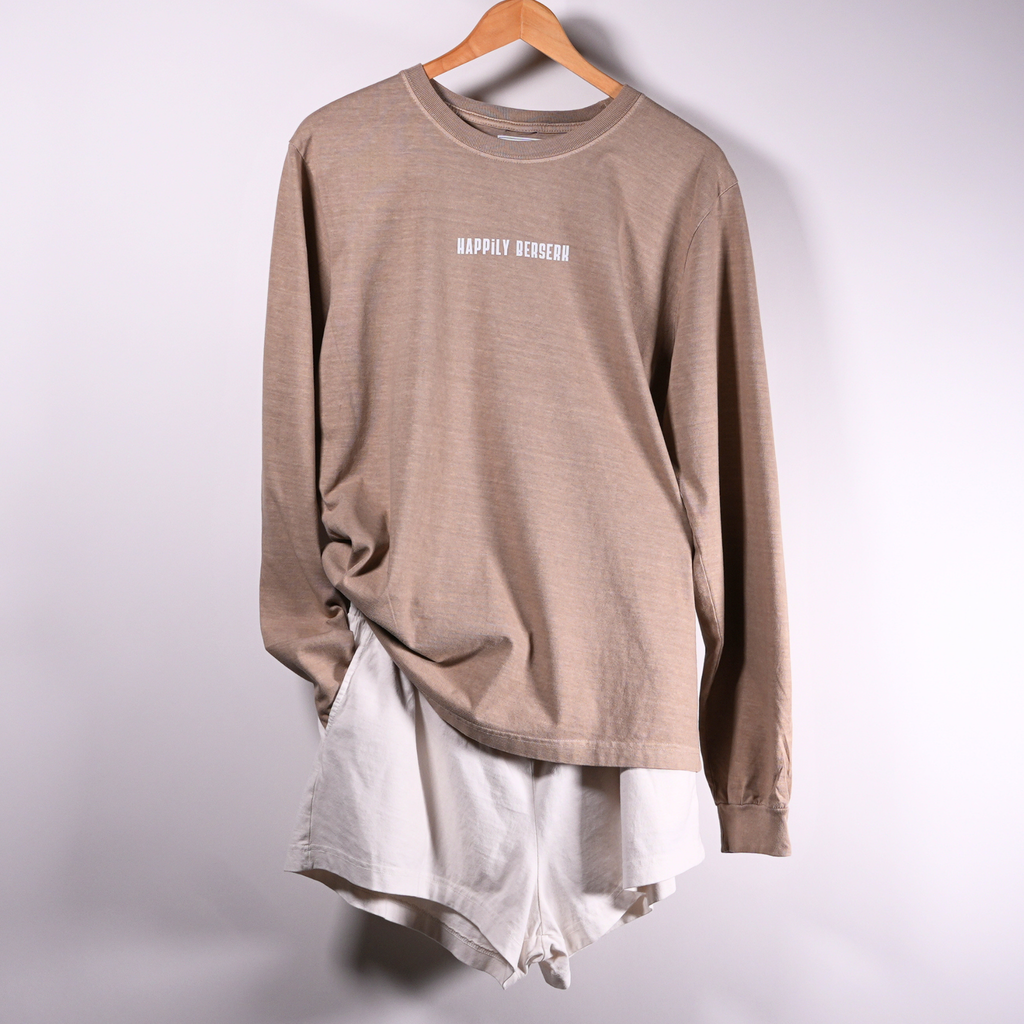 A VINTAGE TAN long-sleeve t-shirt with 'HAPPILY BERSERK' printed in white on the chest, layered over VINTAGE WHITE  HAPPILY BERSERK SHORTS 